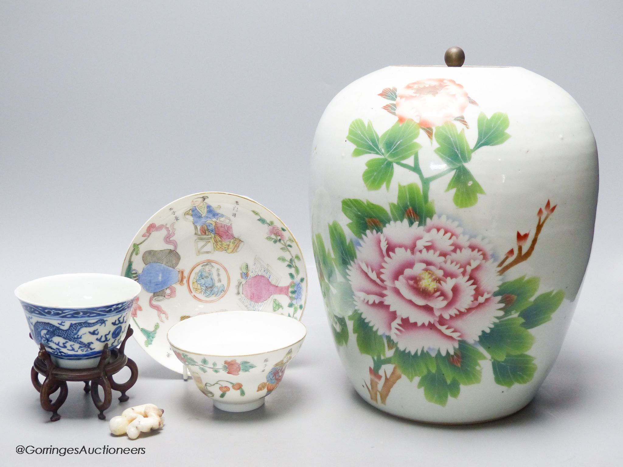 A 19th century famille rose bowl and stand, a blue and white cup, a famille rose jar and a stone carving of two monkeys